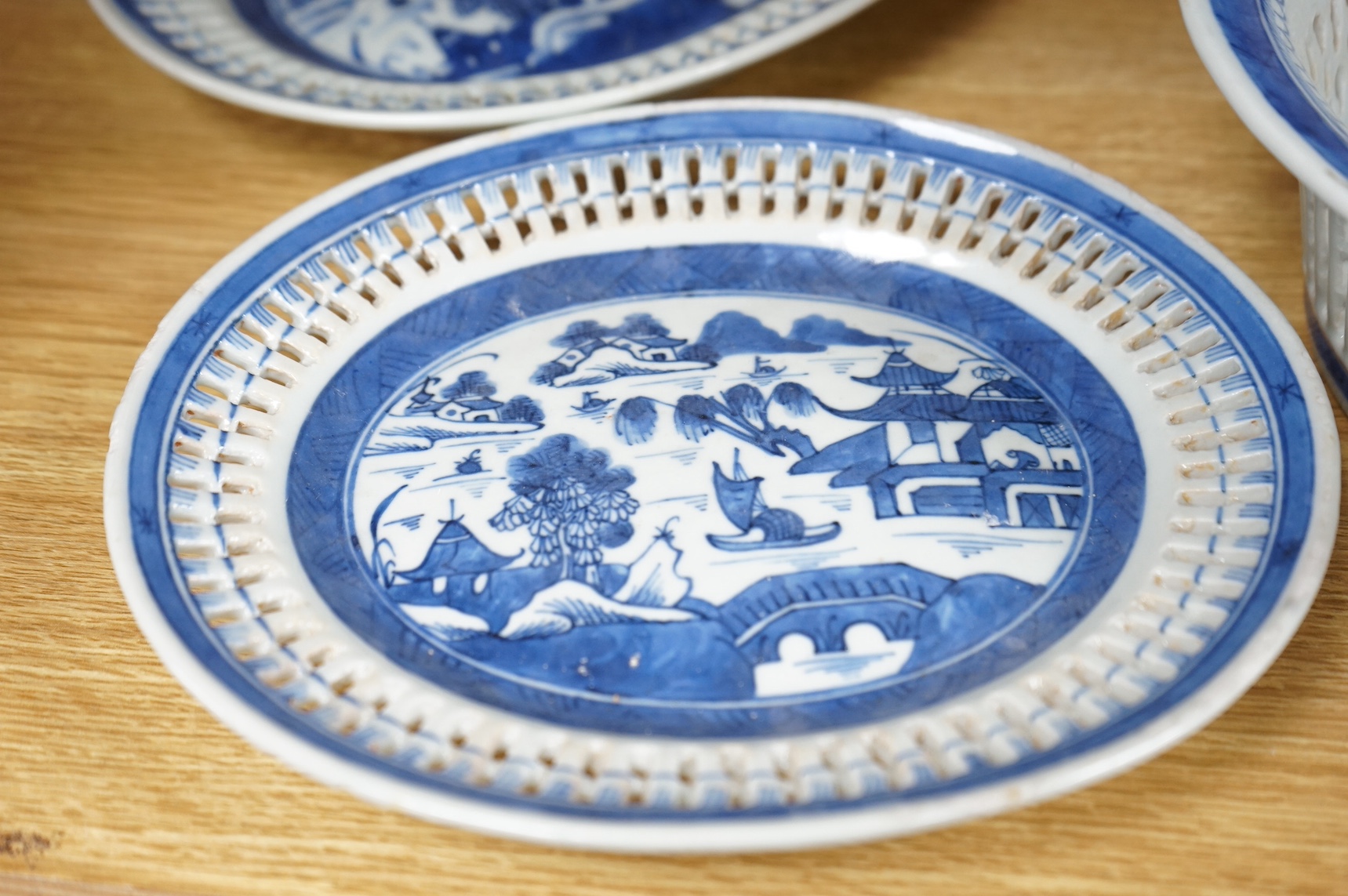 An early 19th century Chinese export blue and white chestnut dish, two related stands and a similar vase, largest 26cm high. Condition - fair